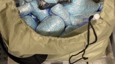 Blue M-30 Fentanyl pills in a bag and on scale with a weight of 43 lbs. showing