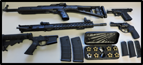 multiple guns and gun accessories displayed on table