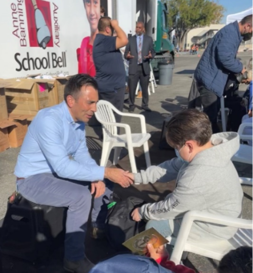 United States Attorney Estrada shaking hands with student