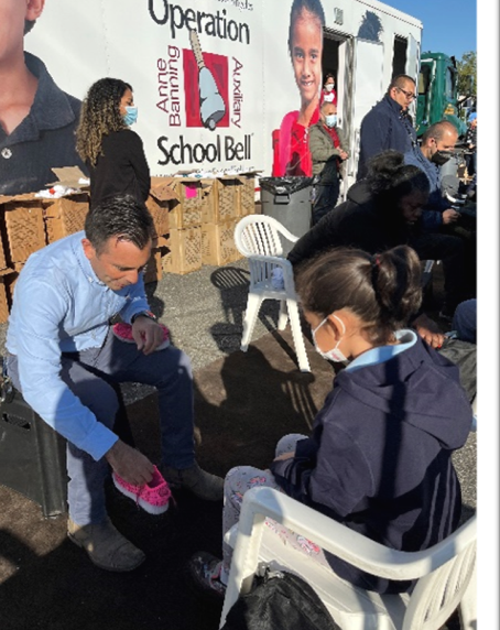 United States Attorney Estrada helping a student