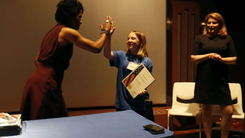 FBI Special Agent in Charge Voviette Morgan presents girl with certificate. FBI Special Agent in Charge Voviette Morgan presents girl with certificate.