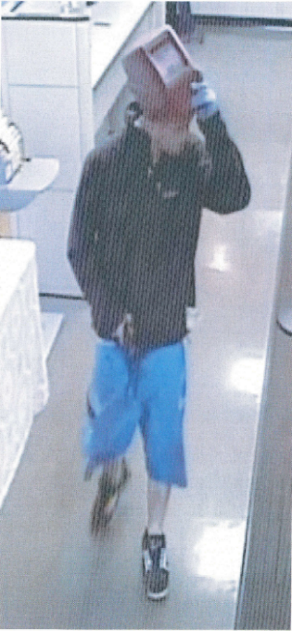 Photo of suspect with mask lifted inside the bank