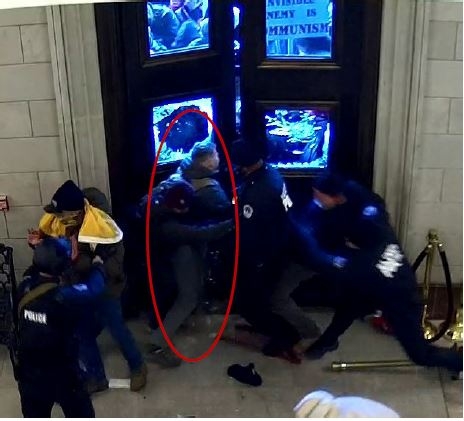 Warnagiris enters the Capitol through the east rotunda doors Security camera footage screenshot
