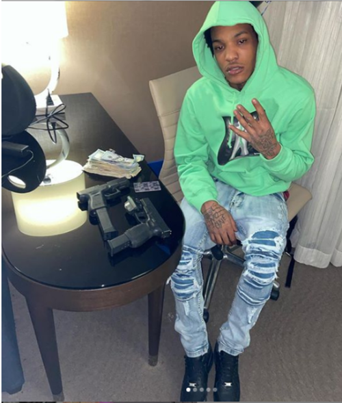 Keylan Williams posted this photo of himself with firearms and cash to his Instagram account.