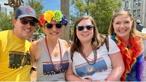 A group of people smile for a photo at the Spokane Pride Parade