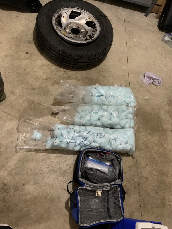 Several large bags containing blue green pills