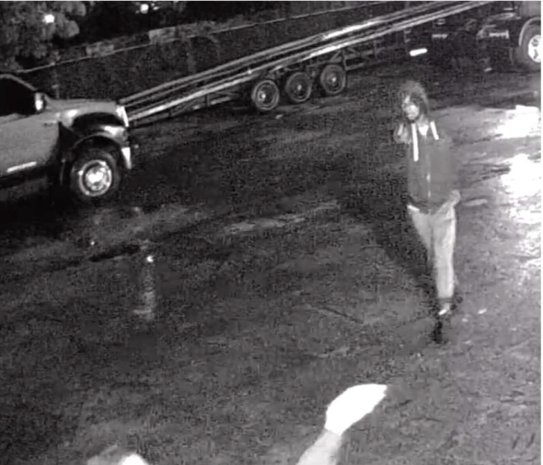 Still image of surveillance video showing defendant Thomas Daniels pointing firearm 
