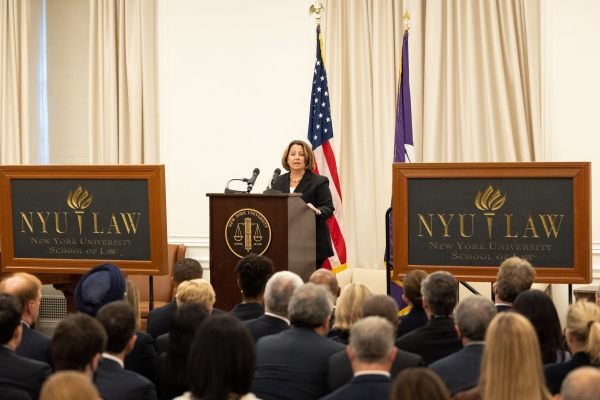 Deputy Attorney General Monaco Delivers Remarks on Corporate Criminal Enforcement Deputy Attorney General Monaco stands at a podium in crowded room with signs for "New York University School of Law"