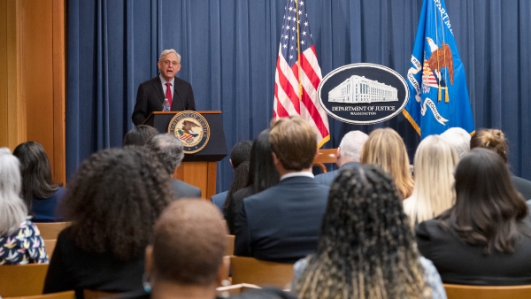 Attorney General Garland delivers opening remarks at the program.