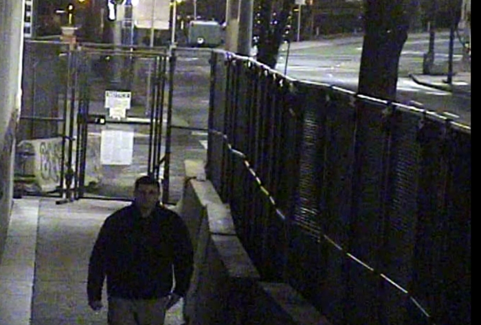 Melby walking inside U.S. Courthouse security fencing