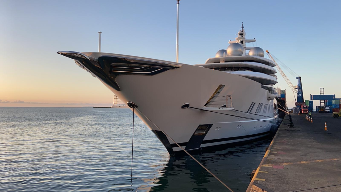 The front end of a large yacht anchored in the water