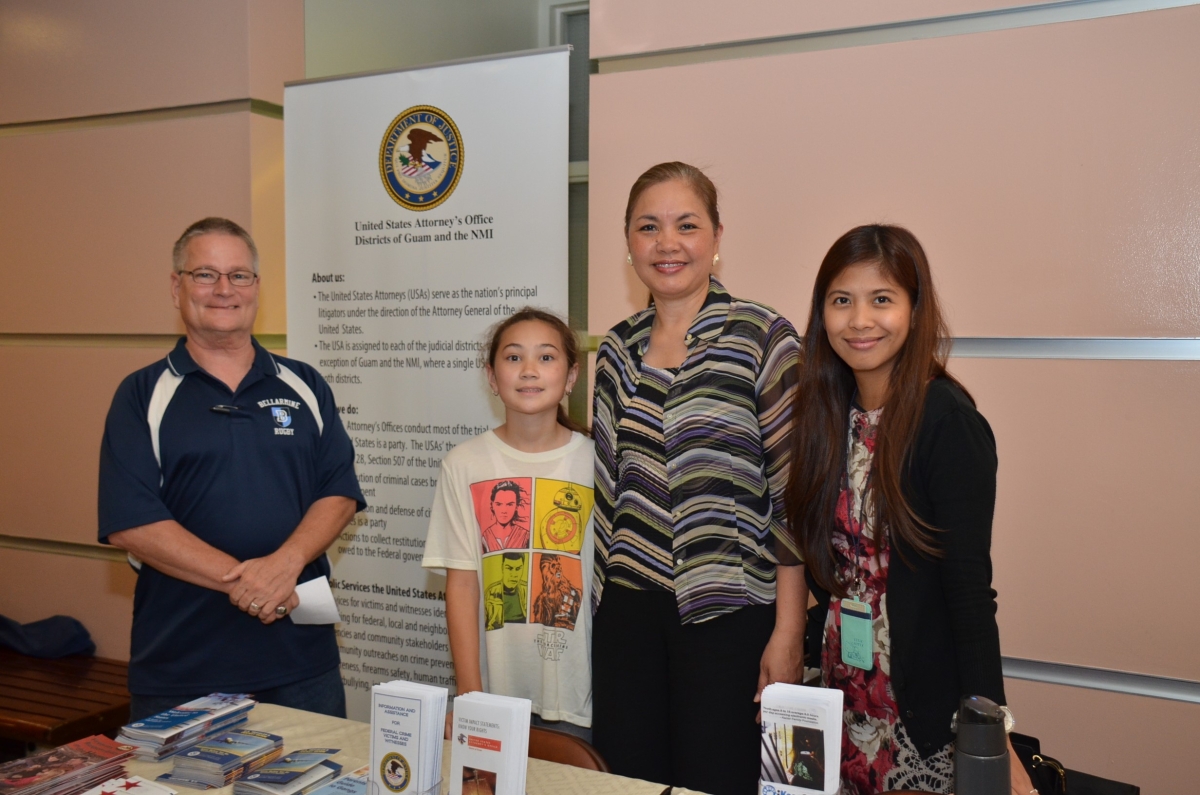 Student Clerk Jack Ruane and his daughter, with U.S. Attorney Alicia Limtiaco and Legal Assistant Roxanne Ferrer at the U.S. Attorney’s Office’s exhibit at the Law Fair held at the Judiciary of Guam Picture of Student Clerk Jack Ruane and his daughter, with U.S. Attorney Alicia Limtiaco and Legal Assistant Roxanne Ferrer at the U.S. Attorney’s Office’s exhibit at the Law Fair held at the Judiciary of Guam