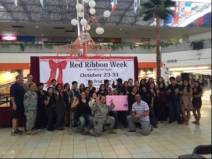 Members of the Red Ribbon Committee with students of the Guam Community College’s sign language class who performed several numbers at the Red Ribbon Campaign Outreach at the Micronesia Mall in Guam Members of the Red Ribbon Committee with students of the Guam Community College’s sign language class who performed several numbers at the Red Ribbon Campaign Outreach at the Micronesia Mall in Guam