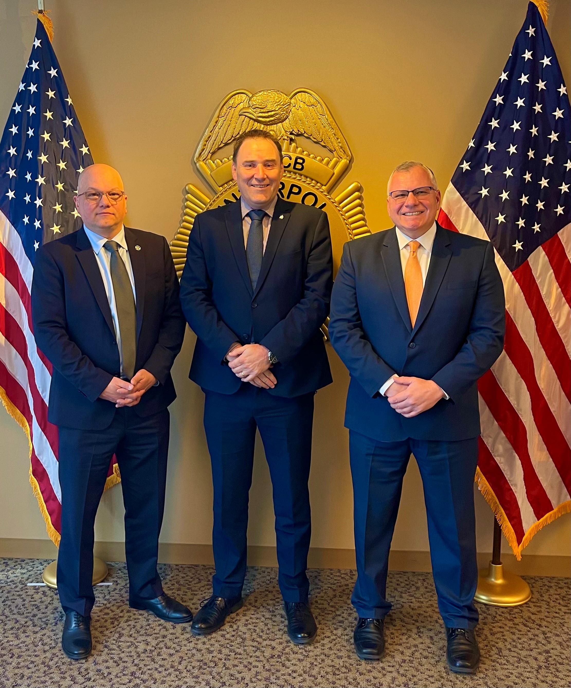 INTERPOL Washington Deputy Director Marc Zimmermann, INTERPOL Cybercrime Director Craig Jones, and INTERPOL Washington Director Michael A. Hughes