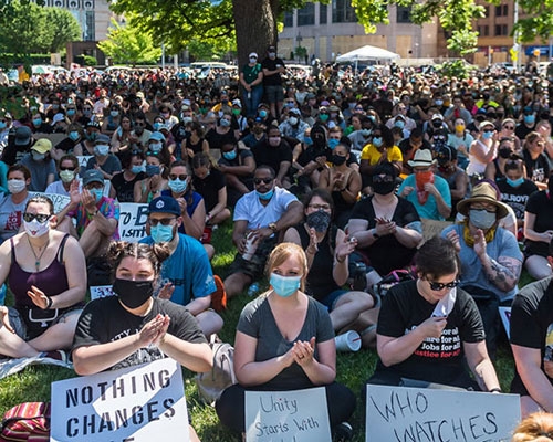 Protesters partake in a sit-in at a local park.