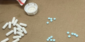 Blue M30 pills and other illicit drugs near a USPS parcel