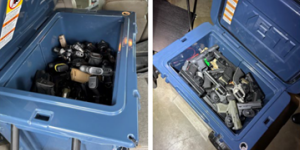 Image of two large coolers filled with handguns. 