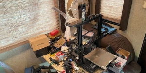 Filament 3D Printer on table with other assorted parts 