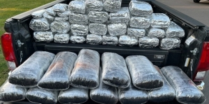 Seized drugs in the back bed of a black pickup truck