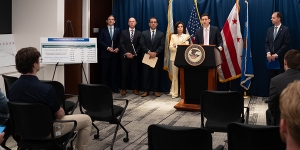 Matthew R. Galeotti delivers remarks from a podium at the United States Attorney’s Office for the District of Columbia. He is joined by Department of Justice and federal government officials.