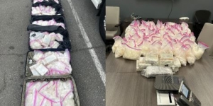 picture of drugs in a suitcase and piled on a table 