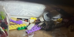 Package of white drugs inside a container with multicolored kids toys. 