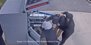 Two masked men are robbing an ATM tech at gun point.
