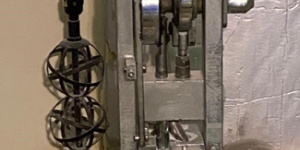 Large hand-crank-style press used for manufacturing pills