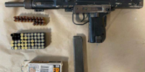 Israel Military Industries UZI model submachinegun containing an extended magazine loaded with 24 rounds 