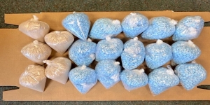 Many plastic bags containing different colored pills