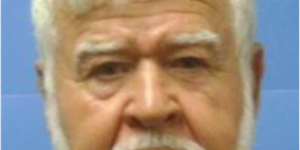 Photo of man in front of blue background