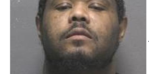 Phone of man standing for photo in black shirt