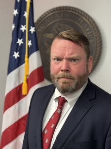 Man in front of flag