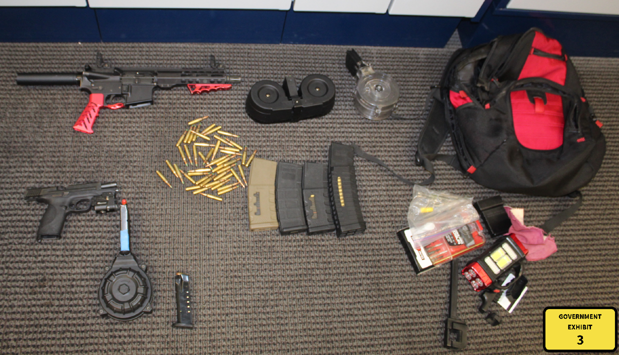 A photo of guns and ammunition seized after an arrest.