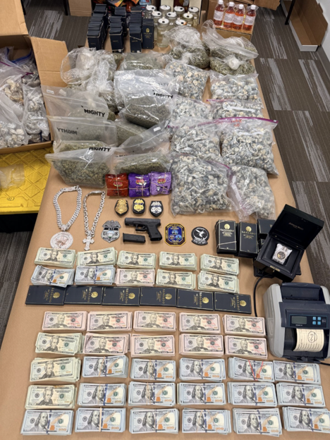 Drugs, money, guns and jewelry on a table