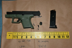 Black gun, gun clip and bullets on a table