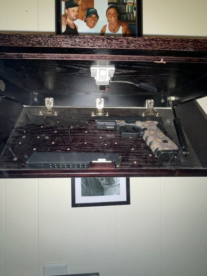 Shelf with hidden compartment and firearm
