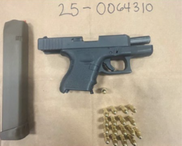 Black gun clip and bullets on beige surface