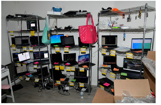 Rows of company-issued laptops with handwritten labels seized from Christina Chapman's Arizona home