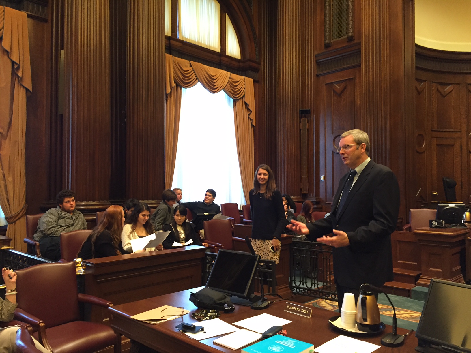 Oana Groza looks on as U.S. District Court Magistrate Judge Lincoln D. Almond explains mitigating factors and sentencing guidelines to her senior class from Barrington High School