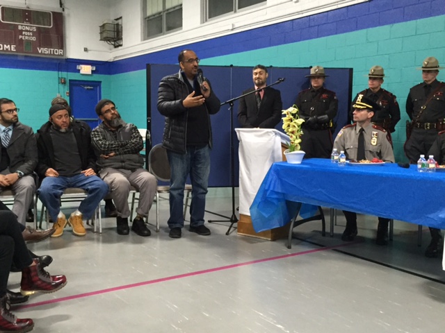 Dr. Nassar Zawia, seated with Imams and community leaders addresses law enforcement and the community