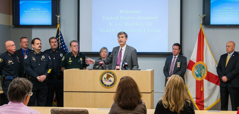 U.S. Attorney presents checks to law enforcement partners.