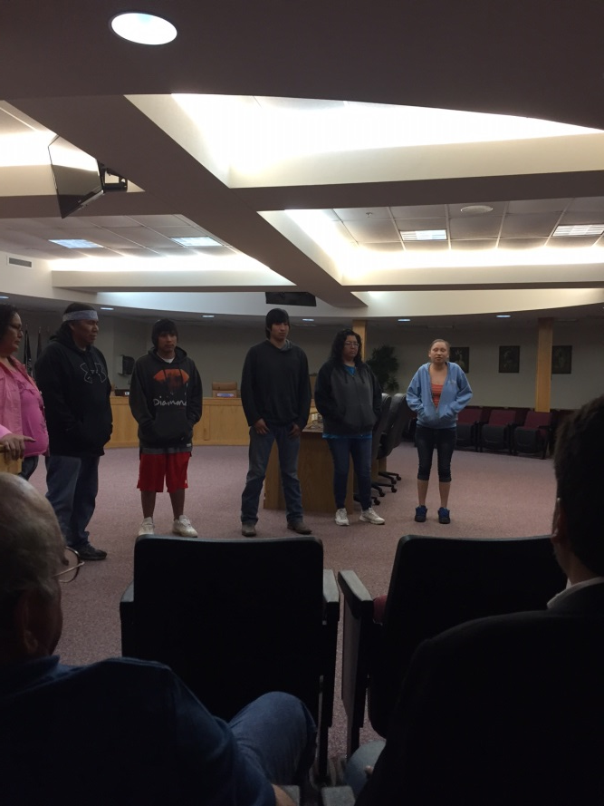 Both Allan Flying By and Emily Yellow Earrings address the crowd and welcome their mentees into the program.
