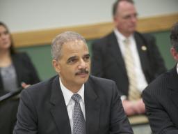 Attorney General Eric Holder takes in a discussion about IP theft at Towson University.