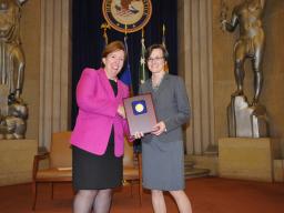 Acting Assistant Attorney General Sharis Pozen presents a 2011 Assistant Attorney General Award to Yvette Tarlov.