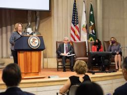 Deputy Attorney General Lisa O. Monaco speaks at a podium with the Department of Justice seal.