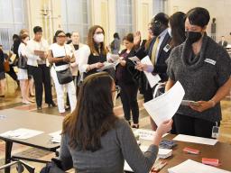 A long line of participants is formed to obtain a simulated identification card.