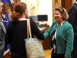 DAG Monaco shakes the hand of a guest at the reception.