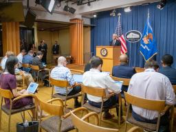 Attorney General Merrick B. Garland speaks to press and media at a podium bearing the Department of Justice seal.