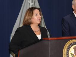 Deputy Attorney General Lisa O. Monaco speaks at the podium at the U.S. Attorney’s Office for the Eastern District of New York